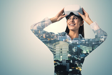 Poster - A woman wearing virtual reality goggles, with a cityscape superimposed, against a plain background, concept of modern technology
