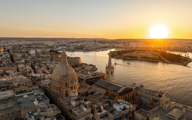 Valletta, Malta - Aerial view of Our Lady of Mount Carmel church, St.Paul's Cathedral and Manoel Island at sunset