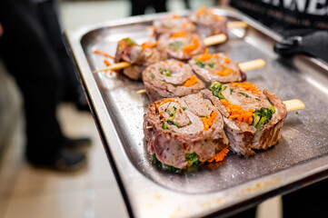 Wall Mural - A tray with skewered rolled meat and vegetables, ready for cooking.