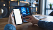 © CreativeIMGIdeas - A person is holding a cell phone and pointing at a phone. The scene suggests that the person is using their phone to control the laptop or is about to do so. Scene is focused and determined