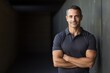 © CogniLens - Portrait of a content man in his 40s wearing a sporty polo shirt while standing against empty modern loft background
