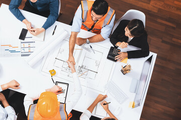 Aufkleber - Top panorama of diverse group of civil engineer and client shake hand after make successful agreement on architectural project, review construction plan and building blueprint at meeting table.Prudent