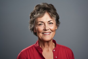 Wall Mural - Portrait of a jovial woman in her 50s donning a classy polo shirt over plain cyclorama studio wall