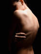 © eugenepartyzan - Nude body silhouette. Naked Woman. Beautiful Back in dark