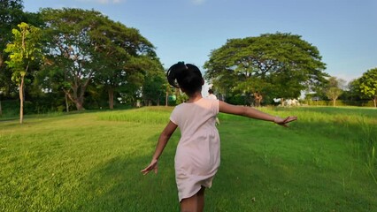 Wall Mural - Small girl raise arm up running at field toward her mother.