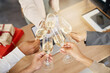 © peopleimages.com - Christmas, toast and hands of people with alcohol in office for party celebration, social gathering and company lunch. Happy team, diversity and workers with champagne for festival, cheers or holiday