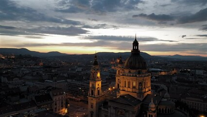 Wall Mural - Aerial video about illuminated  St Stephens basilica at dusk. Hungarian Parlament's building is on the background
