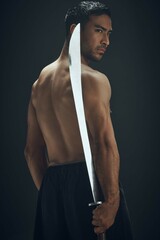 Poster - Samurai sword, man and back in studio for martial arts, training and fitness for tradition or dojo. Blade, wellness and ninja or warrior by black background for battle, fight and karate in Japan