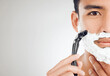© peopleimages.com - Man, razor and foam in studio, grooming and half face for hair removal or epilation. Male person, mockup space and shave beard or facial treatment, cleaning routine and blade on white background
