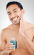 © peopleimages.com - Portrait, man and bottle of aftershave with skincare for razor burn and hair removal in studio. Dermatology, male person and cosmetics product for sensitive skin and cleaning face by white background