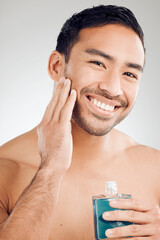 Poster - Skincare portrait, man and bottle of aftershave for hair removal, razor burn and beard in studio. Dermatology, Asian guy and cosmetics product for sensitive skin and cleaning face by white background