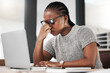© peopleimages.com - Headache, laptop and black woman in office, exhausted with 404 error, eye strain or web glitch. Frustrated, fatigue and tired girl with stress, anxiety and deadline for time management crisis at desk