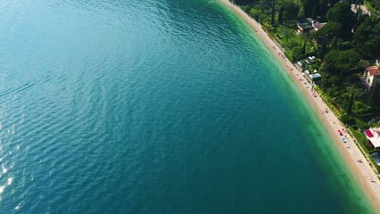 Wall Mural - Garda Lake Garda Aerial View with Beach, Scenic Blue Water and Shoreline, Summer Vacation Destination, Clear Sky and Greenery Background, Copy Space