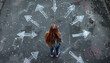 © Oleksiy - Girl standing in front of drawn signs on asphalt, top view. Arrows pointing in different directions symbolizing diversity of opportunities