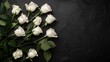 © DZMITRY - White roses on black background. Condolence card with blank space for important words, quotes or sayings. Top view. Flat lay.