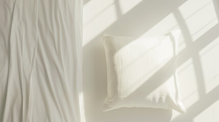 Poster - White pillow on bed with sunlight streaming through window casting shadows. Minimalist and serene bedroom setting perfect for interior design concepts