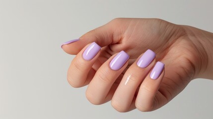 Pale lilac nails on woman s hand against white background for text