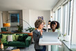 © Marko Geber - Two businesswomen discussing project on laptop in modern office