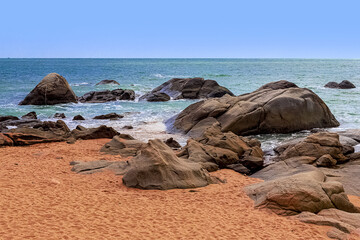 Wall Mural - View of large rocks along the shore of the South China Sea. Sky Grottoes Park, Sanya, China