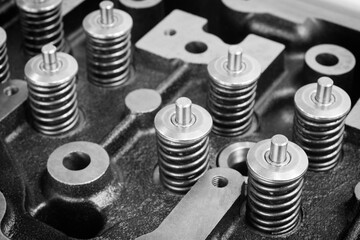 Poster - Close up of valves with many springs on the head of an engine or diesel engine, car repair service concept background, black and white