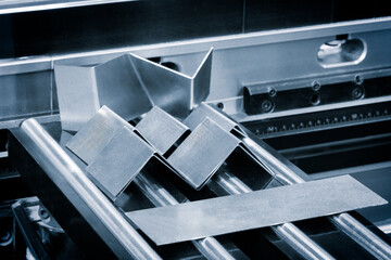 Poster - A metal sheet is being cut into four pieces. Concept of precision and efficiency, as the metal is being cut with a machine
