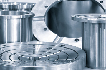 Poster - A collection of metal parts, including a round piece with a hole in the middle. Concept of precision and engineering, as the various parts are arranged in a neat and organized manner