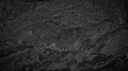 Poster - A black and white photo of a rock wall. The photo is of a large rock wall with a lot of texture and detail. The wall appears to be made of stone and has a rough, uneven surface