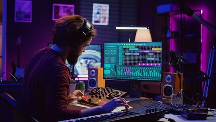 Leinwandbilder - Artist improving the sound quality of audio recordings in home studio, handling mixing console and controls. Producer uses his creative vision to manipulate sounds, audio equipment. Camera B.