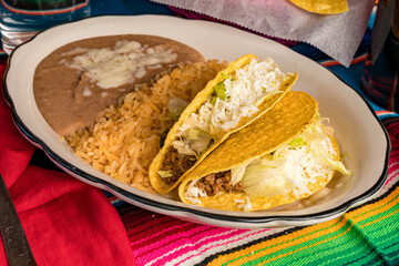 Wall Mural - Two hard shell tacos with refried beans and rice