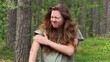 © Евгений Шемякин - Young woman suffering from mosquito bites in the forest