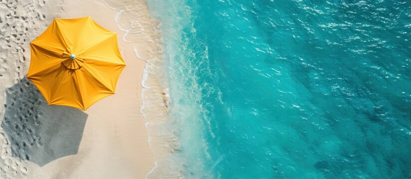 Areal view to the tropical sea or ocean beach with yellow umbrella and sun loungers on the white sand AI generated
