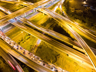 Wall Mural - Aerial view circular intersection transport city road at night with light vehicle movement