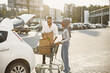 © prostooleh - African arabian couple pack grocery in a car