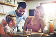 © Reese Coop/peopleimages.com - Breakfast, happy family and love in kitchen for nutrition, support and healthy meal in morning. Parents, kid and smile at table for pancakes, brunch or wellness while together at home for bonding