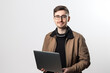 © nddcenter - Smiling businessman working on laptop in office