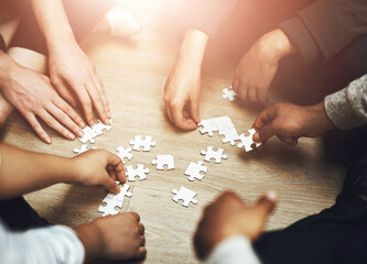 Canvas Print - Hands, puzzle and group in circle with strategy, problem solving and connection for synergy with people. Teamwork, link and solution in scrum, huddle or above for collaboration, community and jigsaw