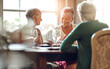 © peopleimages.com - Senior women, friends and smile in restaurant for wine, vacation and retirement together with happy. Elderly people, reunion and relax in diner for drinks, holiday and social celebration with memory