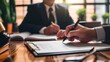 © PhotoMaster - Legal Professional Signing Important Document In Office - Close-up, Lawyer Reviewing Contract With Client - Law And Order Concept, Acting As Legal Advisor And Businessman, Reviews Business Contracts