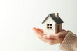 © Andbiz - A small house in his hands. Space for text.
