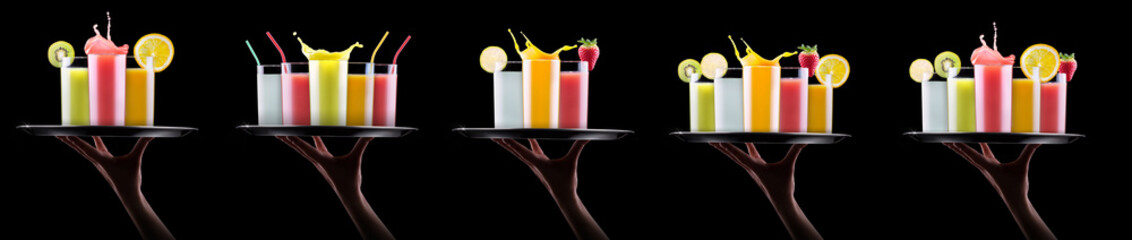 Wall Mural - tasty summer fruit drinks in glass with splash on tray holding a woman hand