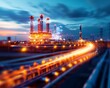 © Narongsak - Illuminated industrial plant with pipelines at twilight showcasing energy infrastructure, industry, and technology in a modern setting.