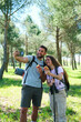 © Ladanifer - A man and a woman are taking a selfie with apples during a hike. They are both smiling and seem to be enjoying their time together