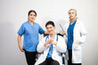 © Nuttapong punna - Successful team of medical doctors looking at camera and smiling while standin. Health, professional and people team in white background