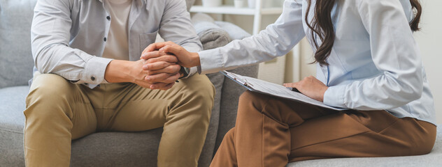 Wall Mural - Psychology, depression. Sad, suffering asian young man, male consulting with psychologist, psychiatrist while patient counseling mental problem with doctor at clinic. Encouraging, therapy, health care