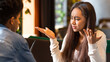 © Prostock-studio - African American young girl with long hair appears frustrated while having an intense discussion with a guy. She is gesturing with her hands, highlighting her apparent confusion or disagreement