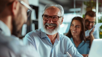 Sticker - A delighted older man engages in a lively conversation with colleagues in a bright office environment.