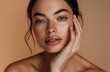 © Cetin - Beautiful woman with smooth, glowing skin touching her face and smiling
