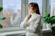 © Valerii Honcharuk - Beautiful happy middle aged woman looking out the window