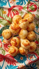 Poster - A bunch of small, golden brown balls are sitting on a red and blue cloth. The cloth has a floral pattern and the balls are arranged in a neat pile