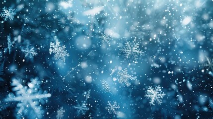 Poster - A close-up image of falling snowflakes against a blurred blue background. The snowflakes are in focus and appear to be falling gently, creating a sense of peace and tranquility. The image is perfect f